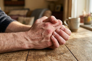 Close-up of male hands showing stiffness or discomfort